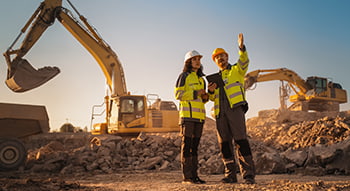 Two construction workers on a job site