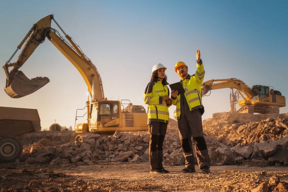 Two construction workers on a job site